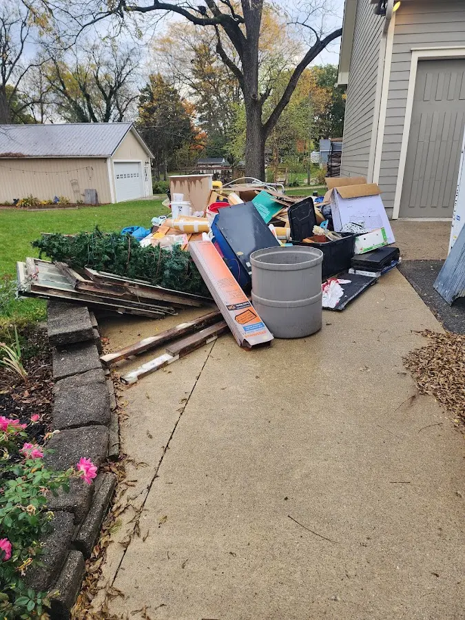 Dumpster being loaded with debris for Residential Dumpster Rental in Dyer